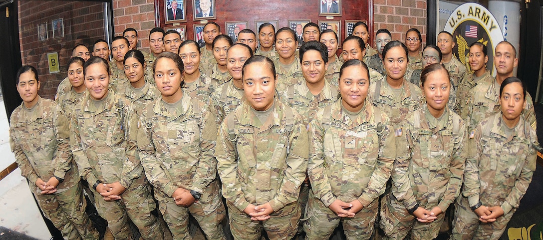 More than 30 members of an American Samoa family pose for pictures at Thompson Hall, Fort Lee, Va., Nov. 8, 2017. The soldiers are advanced individual training students, and most are enrolled in the Unit Supply Specialist Course taught by the Quartermaster School. In all, 41 members of the same Samoan family are training at Fort Lee. Army photo by Terrance Bell