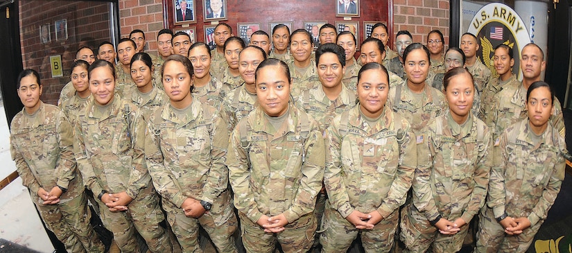 More than 30 members of an American Samoa family pose for pictures at Thompson Hall, Fort Lee, Va., Nov. 8, 2017. The soldiers are advanced individual training students, and most are enrolled in the Unit Supply Specialist Course taught by the Quartermaster School. In all, 41 members of the same Samoan family are training at Fort Lee. Army photo by Terrance Bell