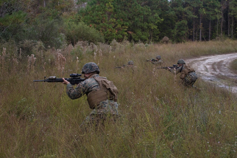 Artillery Marines with 2nd Battalion, 10th Marine Regiment react to enemy contact during a training patrol at Camp Lejeune, N.C., Nov. 14, 2017. Infantry Marines with 3rd Battalion, 8th Marine Regiment taught the artillerymen advanced patrolling tactics in preparation for their upcoming deployment. (U.S. Marine Corps photo by Lance Cpl. Ashley McLaughlin)