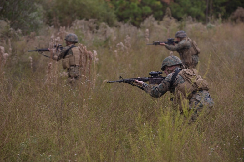 Artillery Marines with 2nd Battalion, 10th Marine Regiment react to enemy contact during a training patrol at Marine Corps Base Camp Lejeune, N.C., Nov. 14, 2017. Infantry Marines with 3rd Battalion, 8th Marine Regiment taught the artillerymen advanced patrolling tactics in preparation for their upcoming deployment. (U.S. Marine Corps photo by Lance Cpl. Ashley McLaughlin)