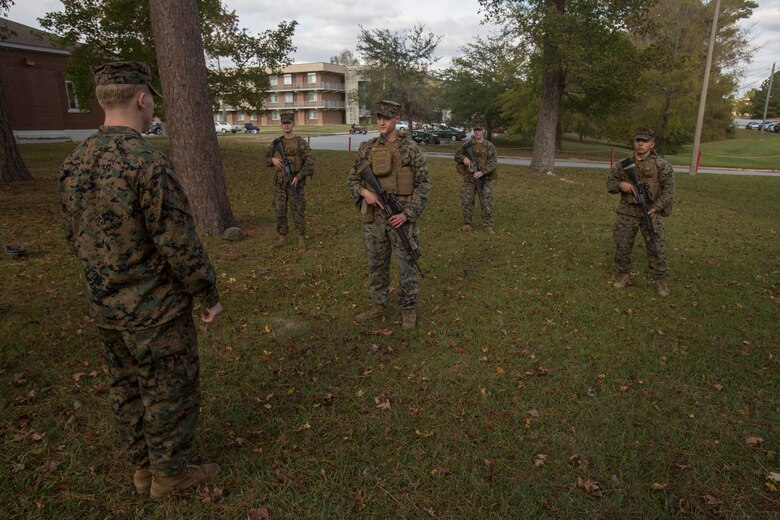 Sgt. Timothy Buntting, an infantry squad leader with 3rd Battalion, 8th Marine Regiment, tests the knowledge of hand & arm signals and patrolling formations of artillery Marines with 2nd Battalion, 10th Marine Regiment at Camp Lejeune, N.C., Nov. 14, 2017. The infantry Marines taught the artillerymen advanced patrolling tactics in preparation for their upcoming deployment. (U.S. Marine Corps photo by Lance Cpl. Ashley McLaughlin)