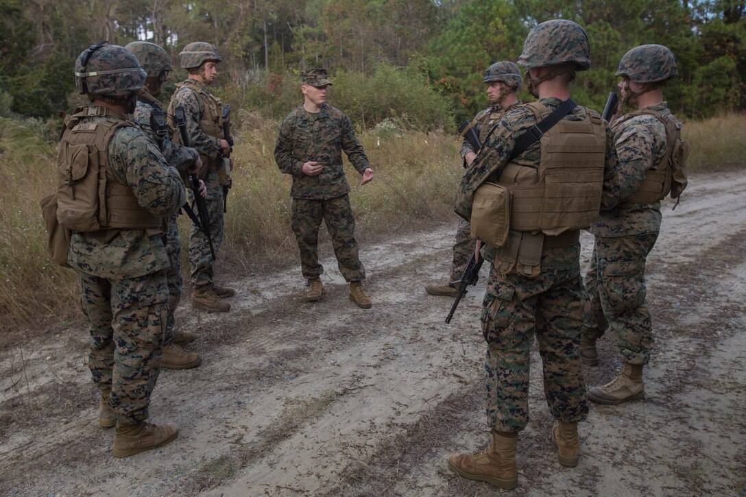 Sgt. Timothy Buntting, an infantry squad leader with 3rd Battalion, 8th Marine Regiment, talks to artillery Marines from 2nd Battalion, 10th Marine Regiment about their performance during a training patrol at Camp Lejeune, N.C., Nov. 14, 2017. The infantry Marines taught the artillerymen advanced patrolling tactics in preparation for their upcoming deployment. (U.S. Marine Corps photo by Lance Cpl. Ashley McLaughlin)