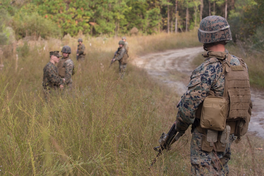 Artillery Marines from 2nd Battalion, 10th Marine Regiment take a pause after reacting to enemy contact during a training patrol at Camp Lejeune, N.C., Nov. 14, 2017. The artillery Marines listen to constructive criticism from an infantry squad leader with 3rd Battalion, 8th Marine Regiment about their execution. The infantry Marines taught the artillerymen advanced patrolling tactics in preparation for their upcoming deployment. (U.S. Marine Corps photo by Lance Cpl. Ashley McLaughlin)