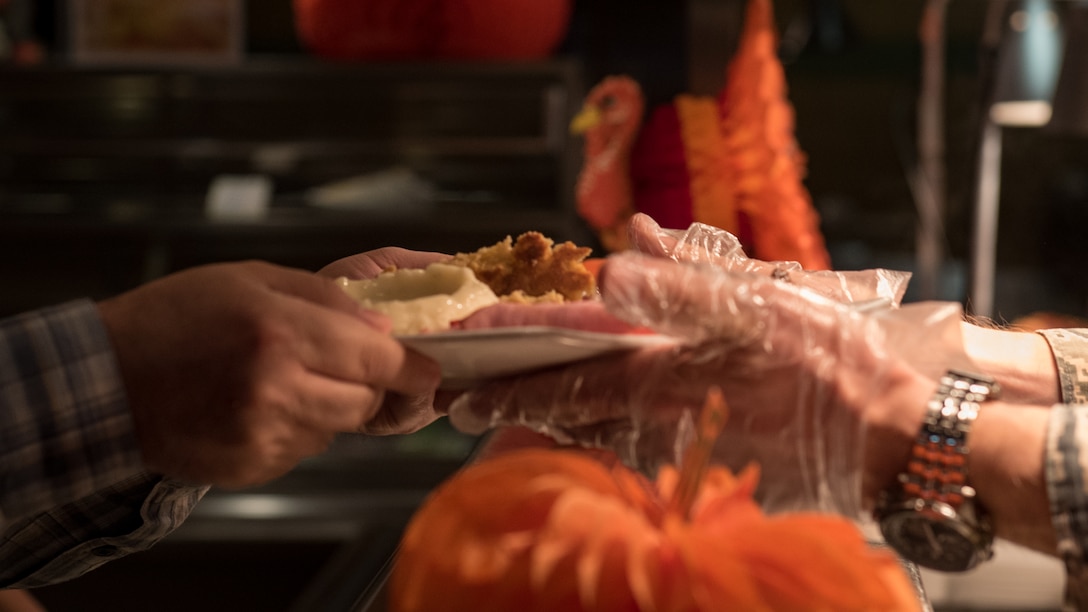 A Langley Air Force Base leader serves Thanksgiving lunch at the Crossbow Dining Facility on Joint Base Langley-Eustis, Va. Nov. 23, 2017.