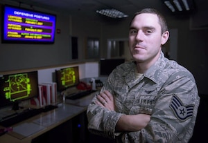 An airman poses for a photograph.