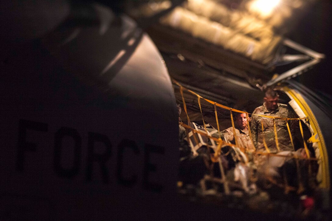 Guardsmen unloading gear from a KC-135 Stratotanker