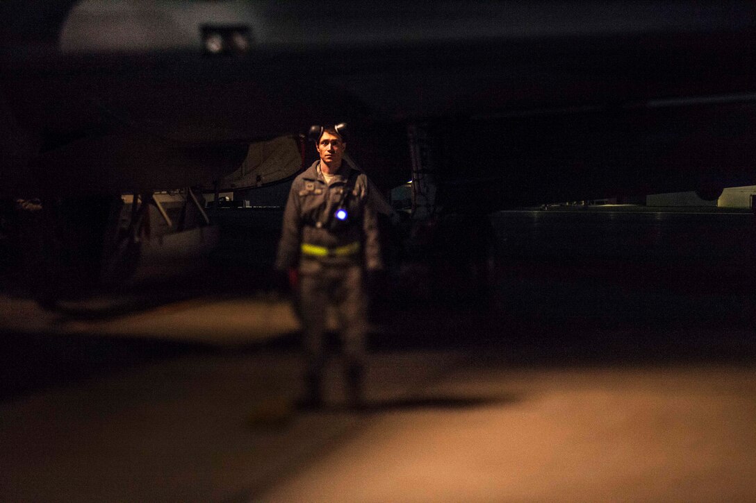 An airman stands by to assist unloading gear from a KC-135 Stratotanker.