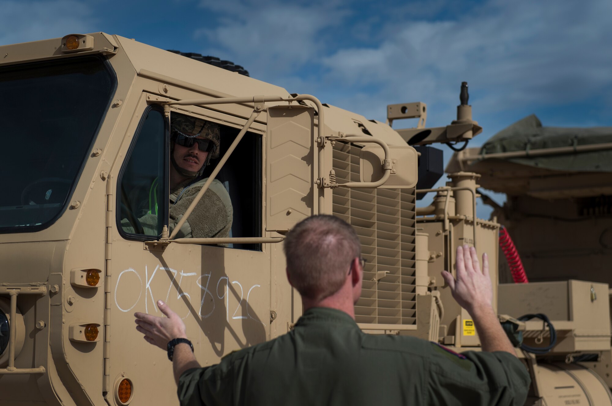 U.S. Air Force Tech. Sgt. Jerry Daniels, a loadmaster instructor with the 58th Airlift Squadron, directs a U.S. Army Soldier assigned to the 4th Battalion 3rd Air Defense Artillery Regiment, while he backs a vehicle onto a C-17 Globemaster III