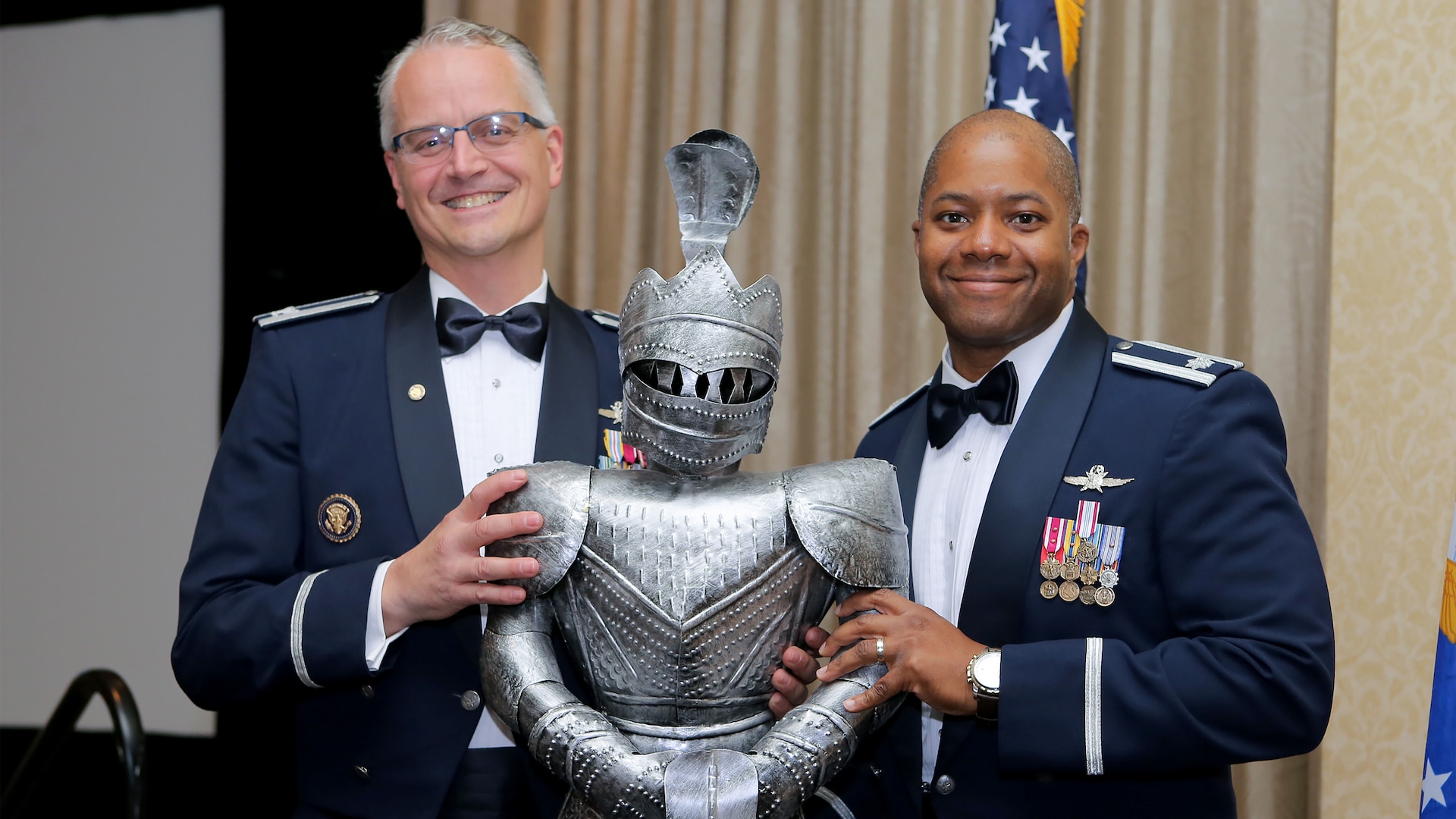 Retired Col. Michael Harasimowicz receives a miniature “demon chaser” from Lt. Col Christopher Robinson, 91st Cyberspace Operations Squadron commander, as a token of appreciation for his speech at the 91st COS centennial dinner in San Antonio, Oct. 28, 2017. The squadron is known as demon chasers, a moniker dating back to World War I. (Courtesy photo)