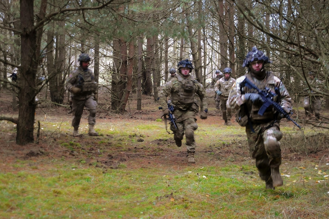 Soldiers advance toward their follow-on objective during a squad live-fire exercise.
