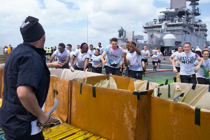 Sailors participate in a crossing-the-line ceremony aboard the amphibious assault ship USS Wasp.