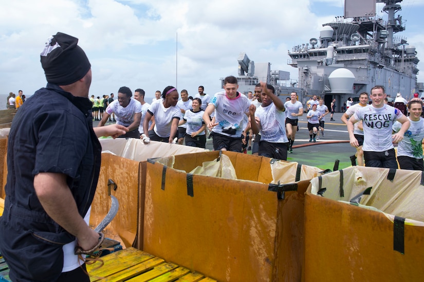 Sailors participate in a crossing-the-line ceremony aboard the amphibious assault ship USS Wasp.