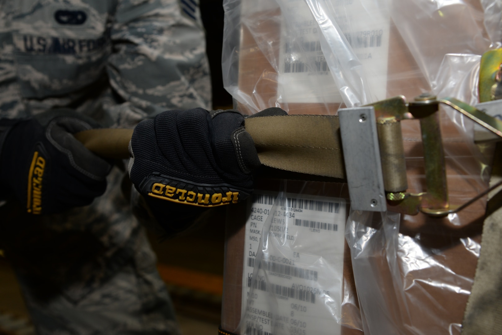 A member of the 436th Aerial Port Squadron cinches a strap on a pallet during a Civil Reserve Air Fleet readiness exercise Nov. 13, 2017, inside the individual protective equipment warehouse on Dover Air Force Base, Del. Members of the 436th APS strapped down the pallets of IPE gear and transported it to a staging area to prepare for flight. (U.S. Air Force photo by Staff Sgt. Aaron J. Jenne)