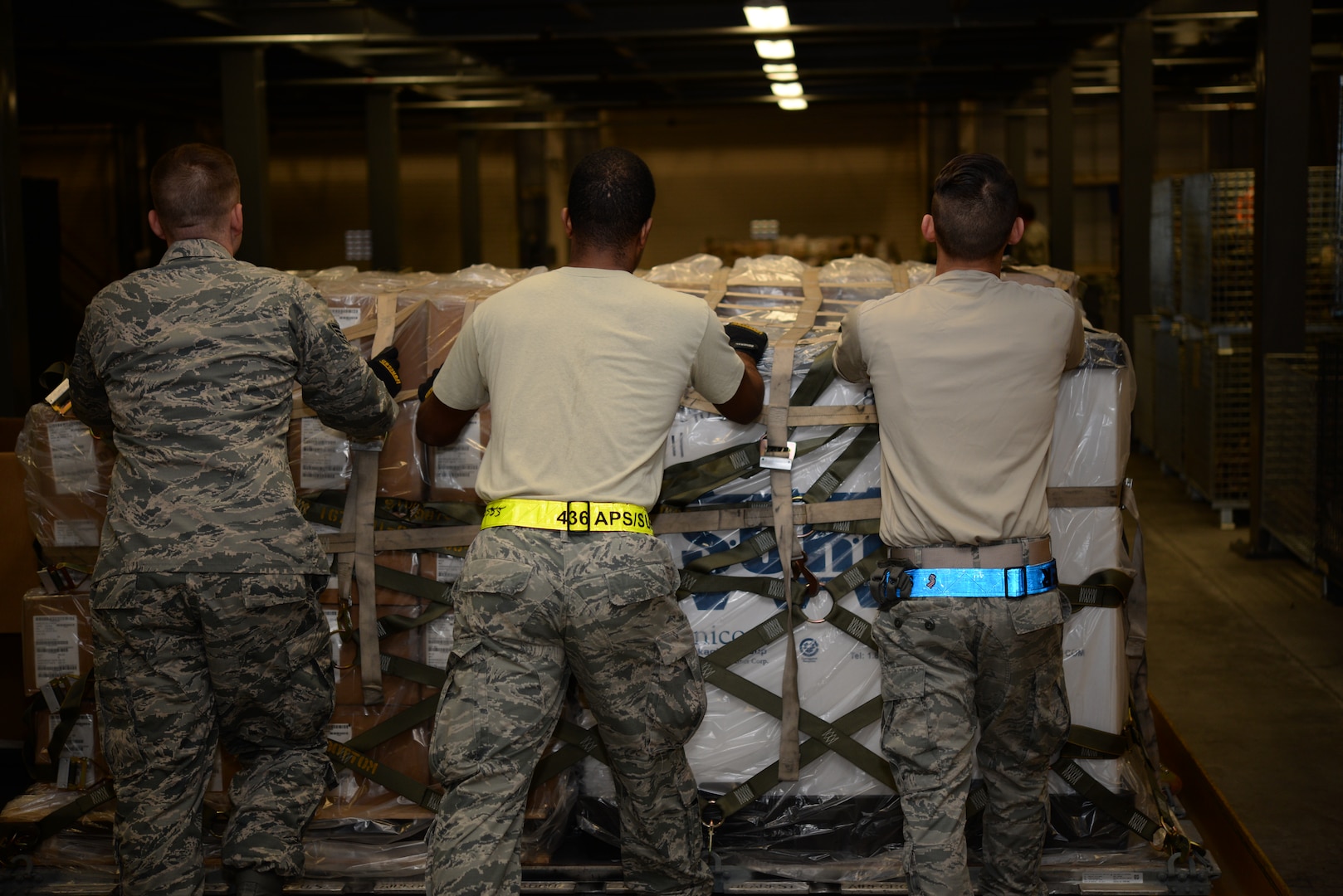 Members of the 436th Aerial Port Squadron move a pallet of individual protective equipment during a Civil Reserve Air Fleet readiness exercise Nov. 13, 2017, at Dover Air Force Base, Del. Members of the 436th LRS worked hand-in-hand with members of the 436th APS to prepare the IPE for flight. (U.S. Air Force photo by Staff Sgt. Aaron J. Jenne)