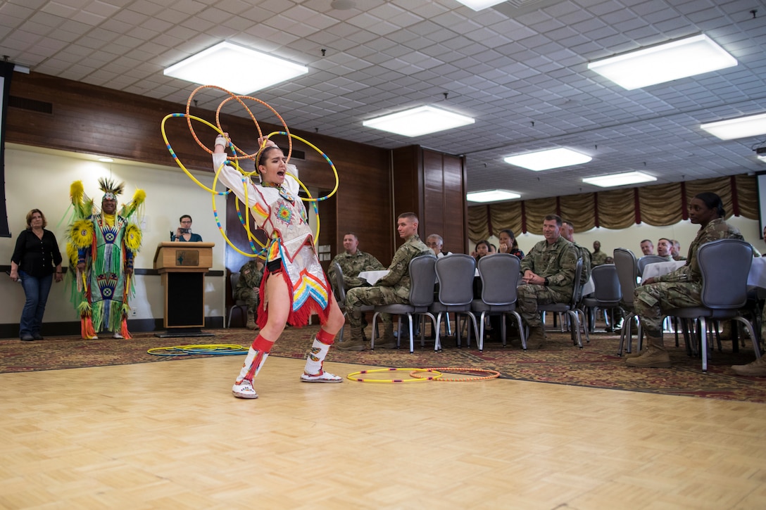 A Native American dancer performs a hoop dance