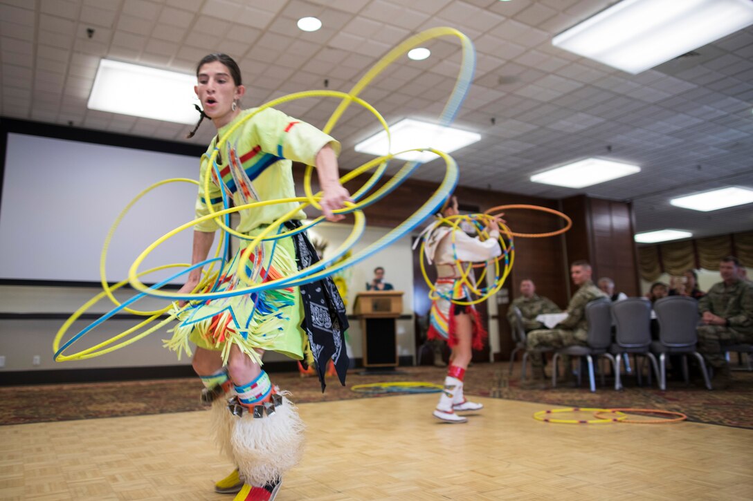 Native American dancers perform with hoops.