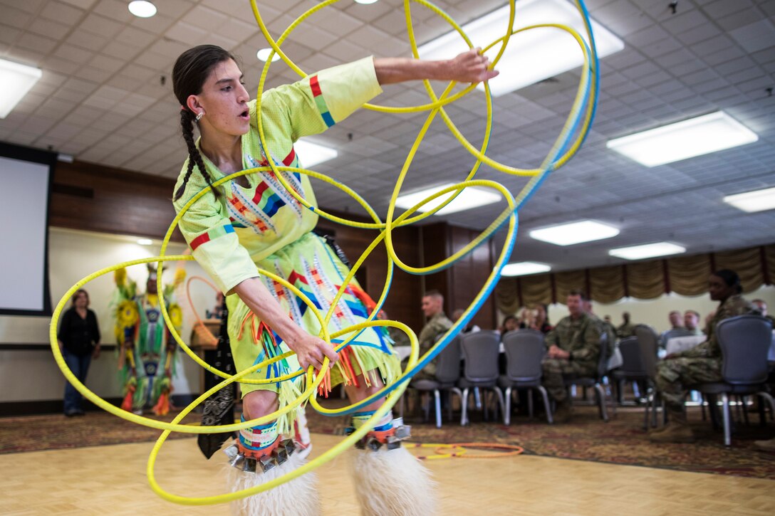 A Native American dancer performs with hoops.