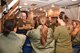 An aircrew member with the 964th Airborne Air Control Squadron gives a safety briefing prior to take off to a group of spouses participating in a spouse orientation flight on the E-3 Sentry aircraft 28 Nov. 2017.