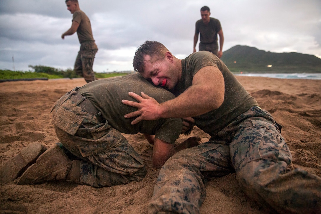 Two Marines grapple on the beach