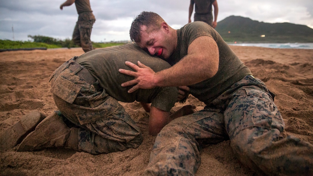 Two Marines grapple on the beach