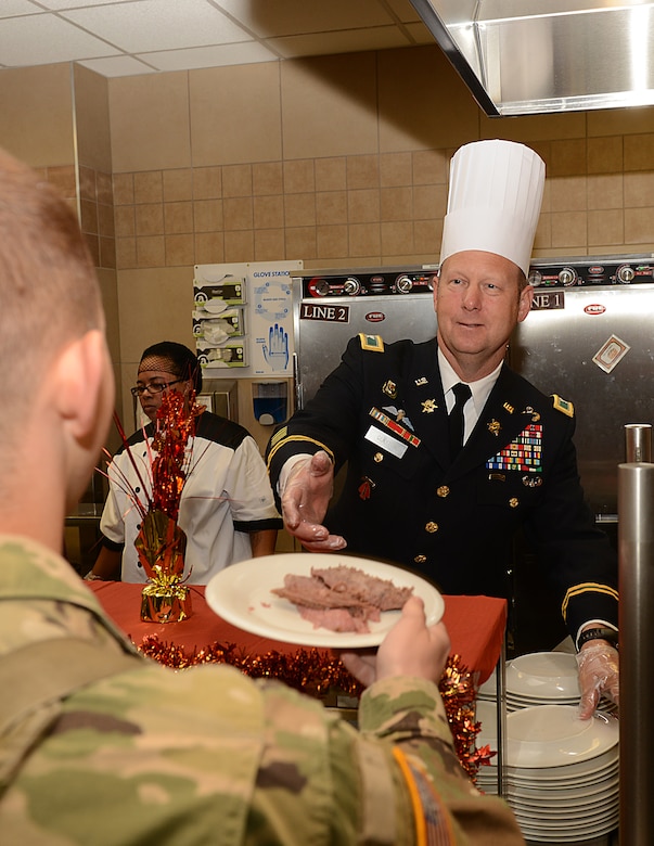 U.S. Army Col. Ralph Clayton III, 733rd Mission Support Group commander, serves Thanksgiving lunch at the Warrior Cafe on Joint Base Langley-Eustis, Va., Nov. 23, 2017.