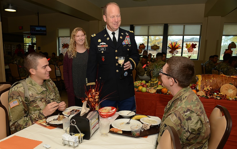 U.S. Army Col. Ralph Clayton III, 733rd Mission Support Group commander, and his daughter Christina, socialize with U.S. Army Soldiers during Thanksgiving lunch at the Warrior Cafe on Joint Base Langley-Eustis, Va., Nov. 23, 2017.