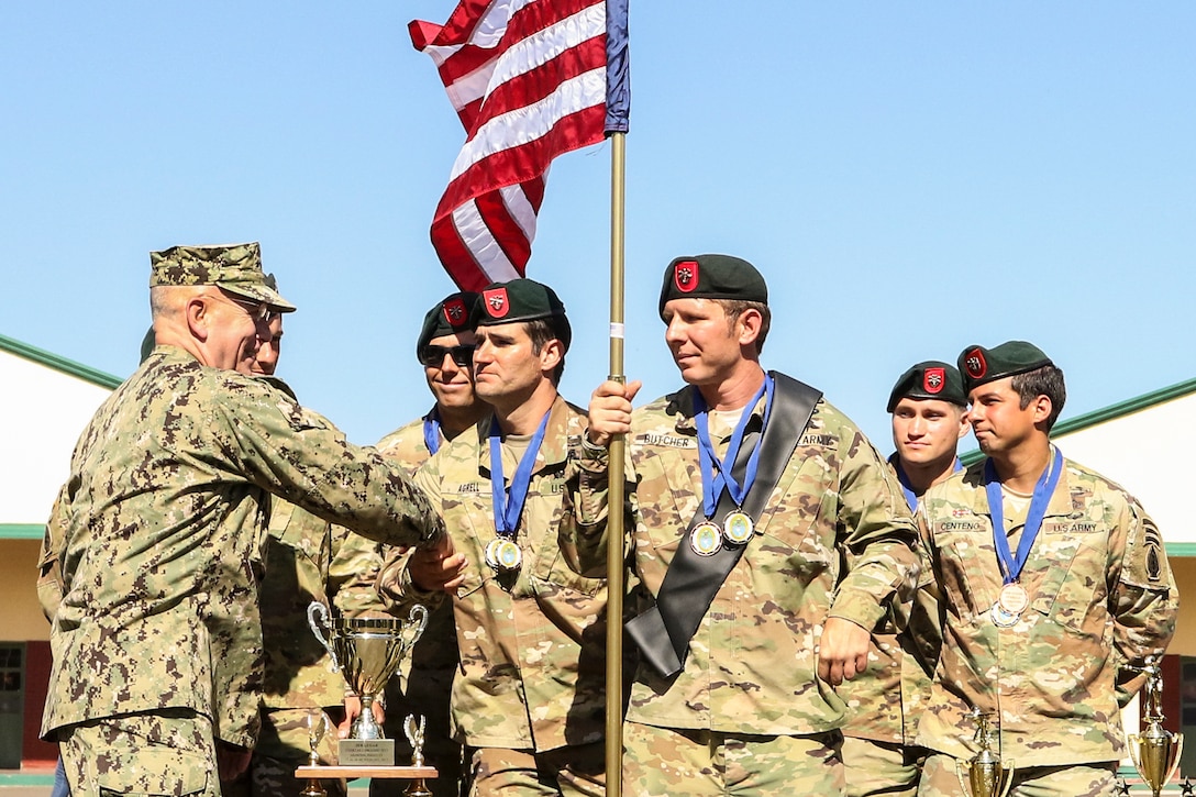 The commander of U.S. Southern Command shakes hands with soldiers.