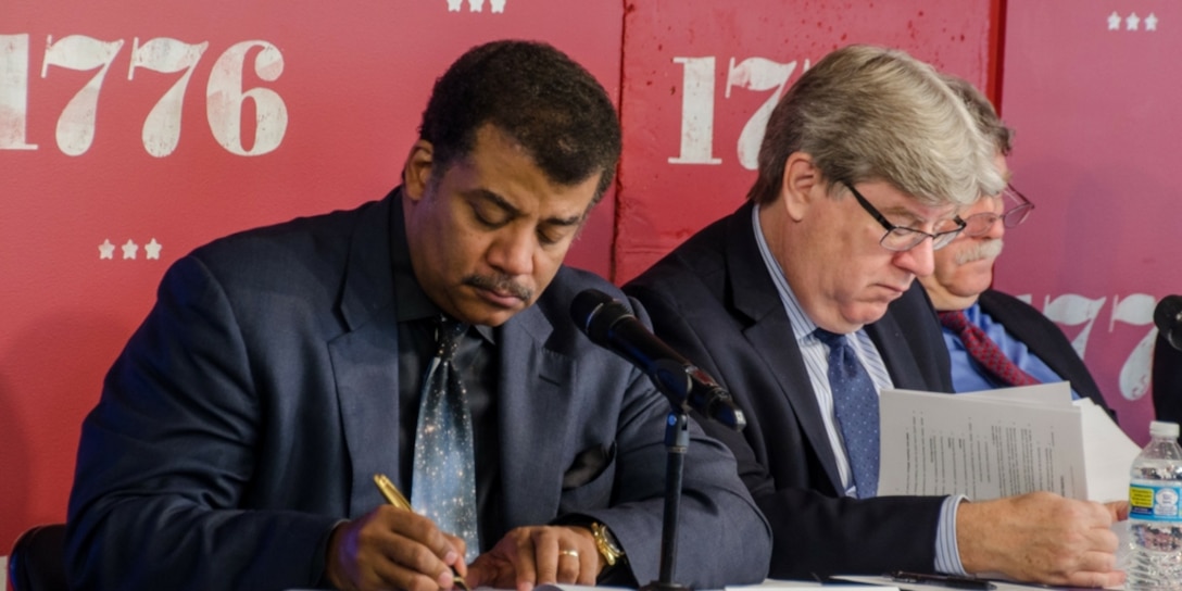 Astrophysicist and author Neil deGrasse Tyson takes notes during the Defense Innovation Board's fifth public meeting. Chaired by Eric Schmidt, executive chairman of Google parent company Alphabet Inc., DIB was established a year ago to help identify innovative private-sector practices and technological solutions that the Department of Defense could employ in the future.
