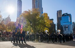 Band and Honor Guard march in parade