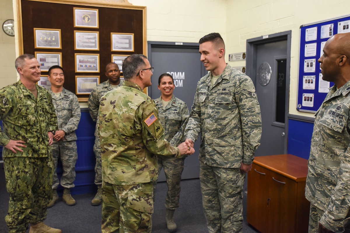 The commander of  U.S. European Command NATO's supreme allied commander for Europe coins an airman during training.