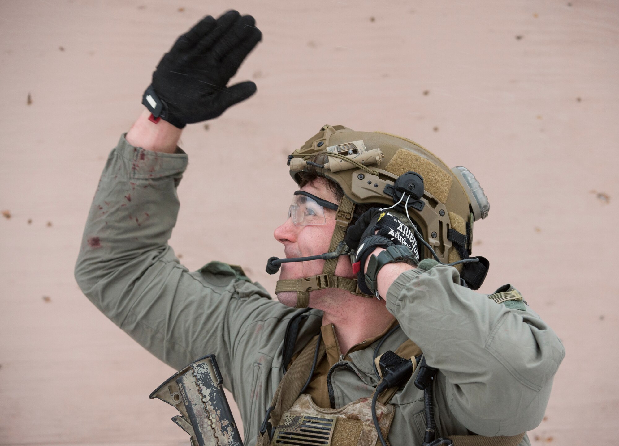An Alaska Air National Guard pararescueman with the 212th Rescue Squadron communicates with an incoming helicopter while conducting medical evacuations during a mass-casualty training event at Joint Base Elmendorf-Richardson, Alaska, Nov. 21, 2017.