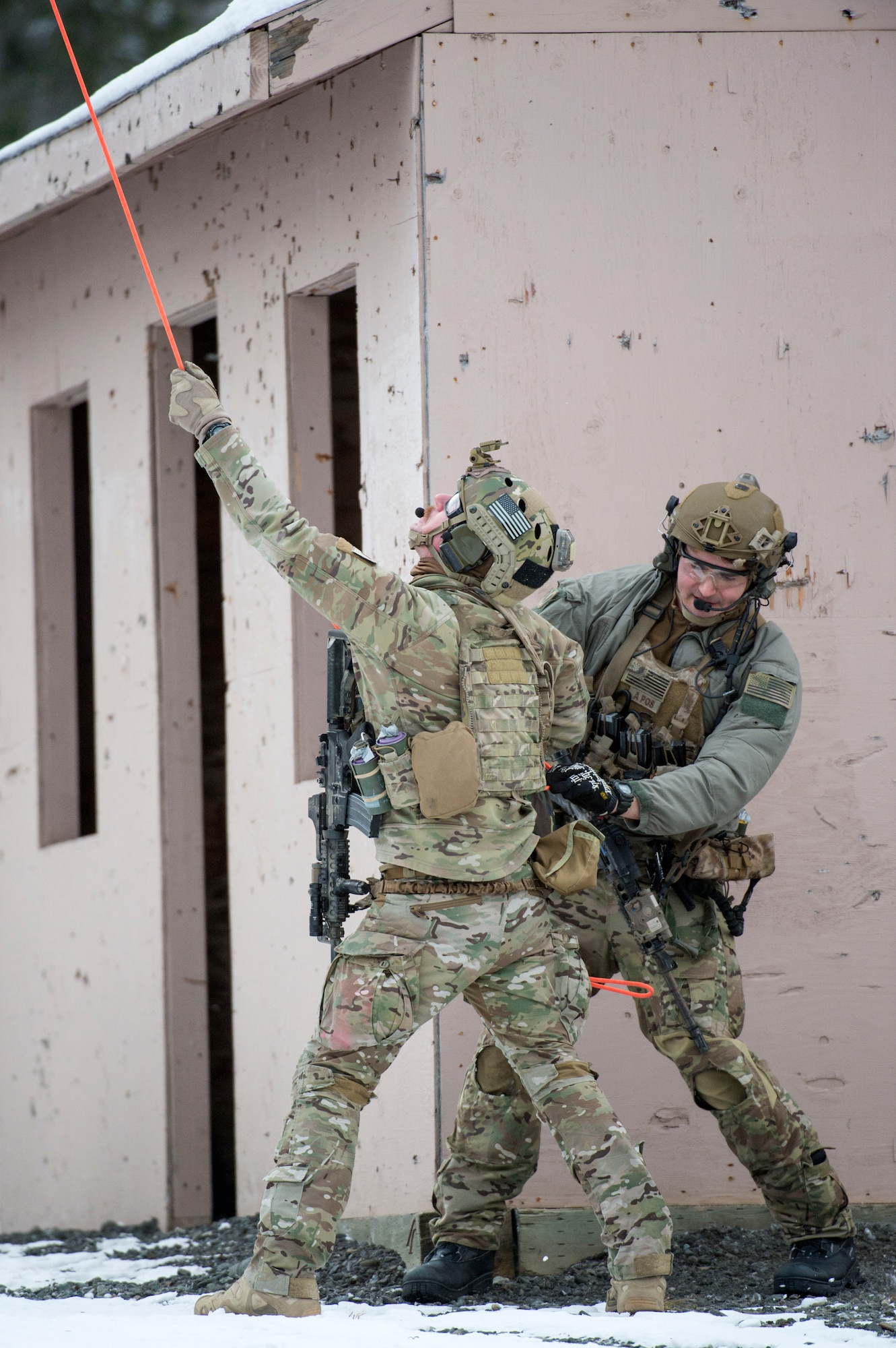 Alaska Air National Guard pararescuemen with the 212th Rescue Squadron stabilize a patient stretcher as it is hoisted up to a helicopter during a mass-casualty training event at Joint Base Elmendorf-Richardson, Alaska, Nov. 21, 2017.