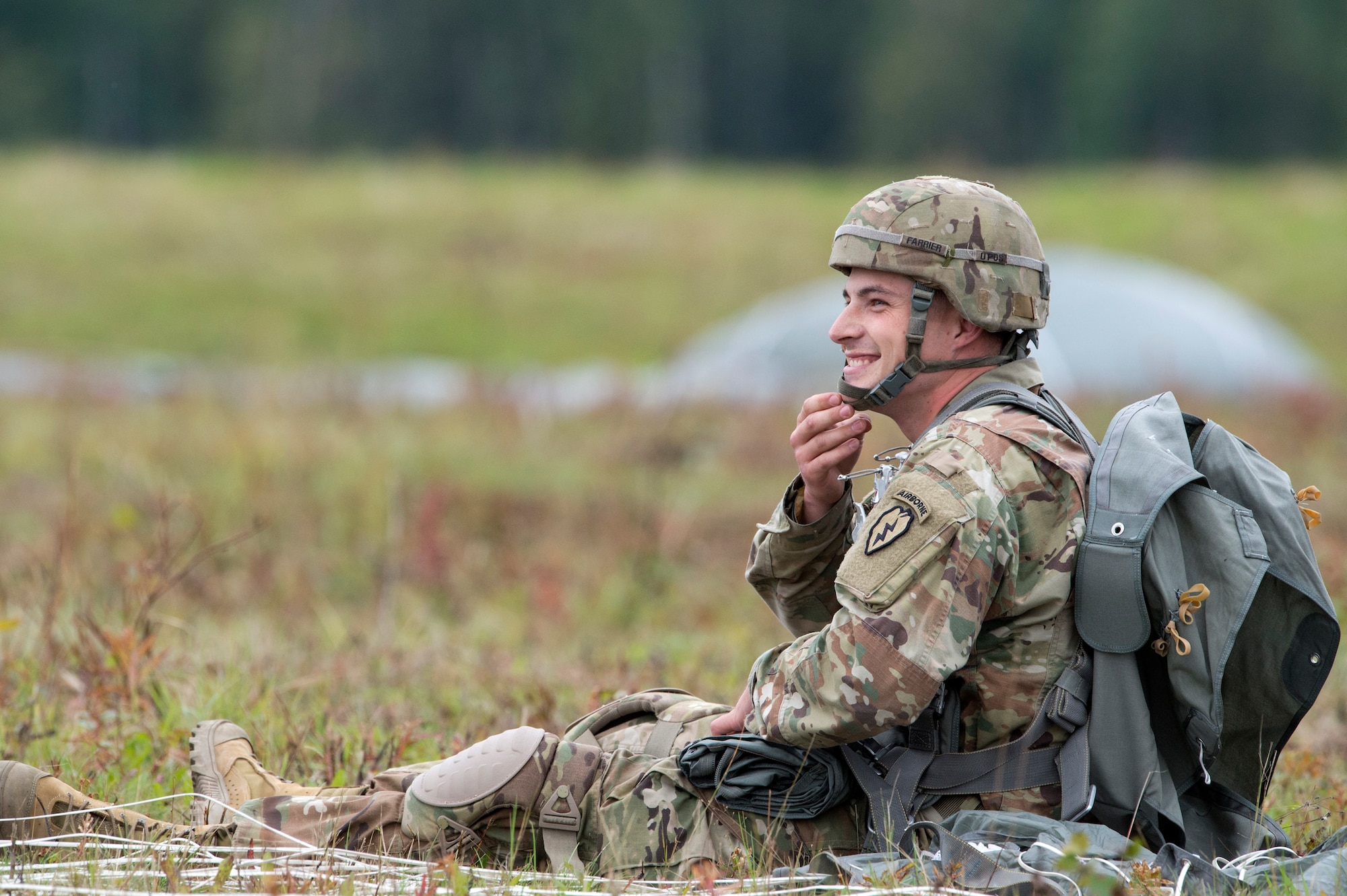 Sgt. Benjamin Farrier, a paratrooper assigned to Bravo Battery, 2nd Battalion, 377th Parachute Field Artillery Regiment, 4th Infantry Brigade Combat Team (Airborne), 25th Infantry Division, U.S. Army Alaska, smiles after completing airborne jump training at Malemute drop zone, Joint Base Elmendorf-Richardson, Alaska, Aug. 24, 2017.