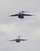 Two U.S. Air Force C-17 Globemaster IIIs, assigned to the 3rd Wing and the 437th Airlift Wing out of Joint Base Charleston, respectively, fly over Malemute drop zone before conducting airborne jump training at Joint Base Elmendorf-Richardson, Alaska, Aug. 24, 2017.