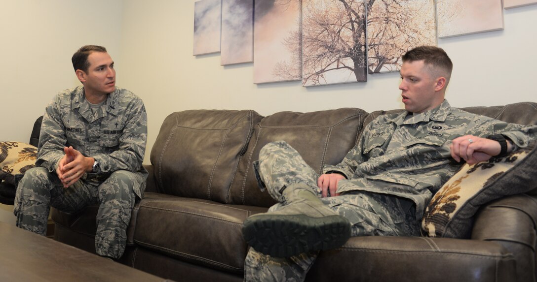 Chaplain 1st Lt. Raidel Leon-Martinez, a Chaplain assigned to the 28th Bomb Wing, speaks to Staff Sgt. Brendan Sparks, the non-commissioned officer in charge of plans and programs, about his plans for the upcoming holidays at Ellsworth Air Force Base, S.D., Nov. 21, 2017. Chaplaincy means taking care of Air Force personnel by supporting and creating programs that promote happy families and unit cohesion. (U.S. Air Force photo by Airman 1st Class Thomas Karol)