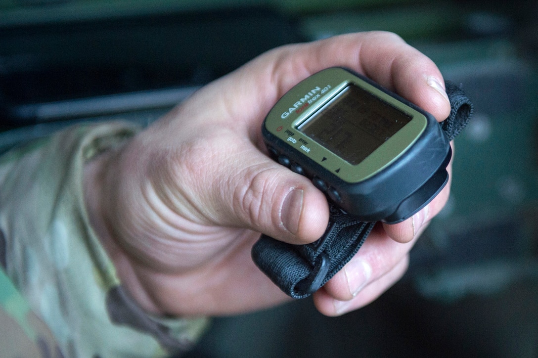 An airman holds a global positioning system device
