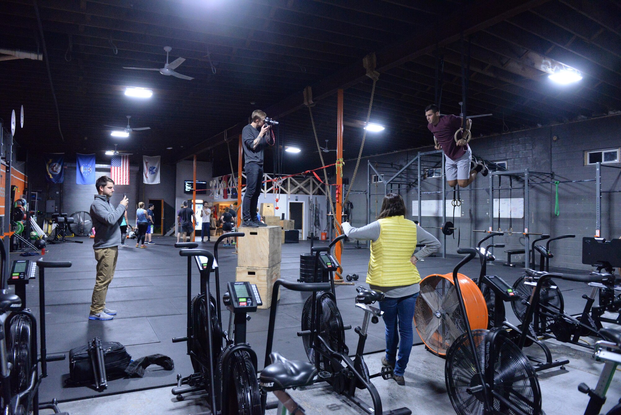 The crew from Futures magazine watch as Senior Airman Alexander Triani, a pararescueman with the 103rd Rescue Squadron of the 106th Rescue Wing assigned to the New York Air National Guard, is photographed doing muscle-ups at a CrossFit Gym in Bayport New York November 1, 2017.