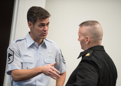 Air Force Chief Master Sgt. Ronald Thompson, senior enlisted leader of the chief of staff of the Air Force's Focus Area 2, speaks with Army Command Sgt. Maj. John W. Troxell, senior enlisted advisor to the chairman of the Joint Chiefs of Staff, before an Enlisted Military Education Review Council meeting at National Defense University in Washington, Nov. 20, 2017. The council met to discuss joint enlisted leader development, talent management and service education initiatives. DoD photo by Army Sgt. James K. McCann