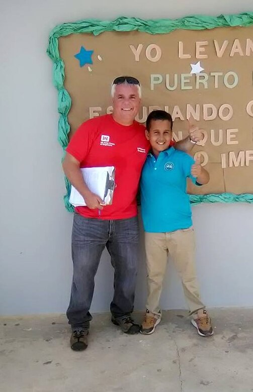 USACE infrastructure assessment inspection team leader James Scungio, left, with Angel Emanuel Martinez Mateo, a student at the Benigna L. Caratini School.