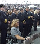 Carlana Stone (center), seen here in attendance at the Pentagon Memorial Dedication Ceremony on Sept. 11, 2008, is scheduled to speak Army Soldiers and units on Dec. 8 as part of the U.S. Army North (Fifth Army) and the Army’s Ready and Resilient program. Stone lost the use of her legs in an accident when she was 16 years old and shares her story of recuperation and triumph to motivate and empower others with their own struggles.