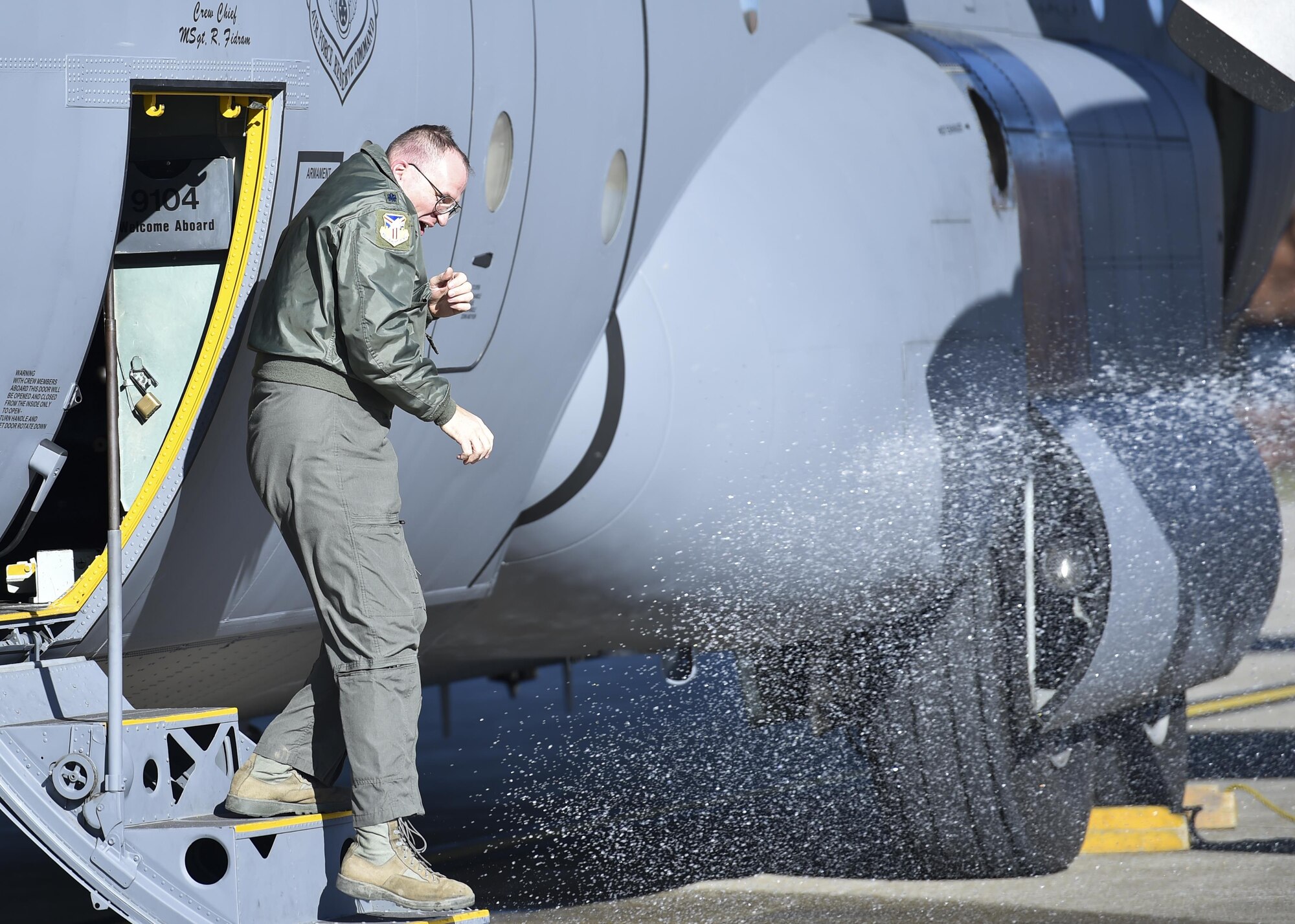 Lt. Col. Chris Zwetzig, a navigator with the 757th Airlift Squadron, gets hosed down by his sons as he steps off a C-130H Hercules aircraft here, Nov. 28, 2017.