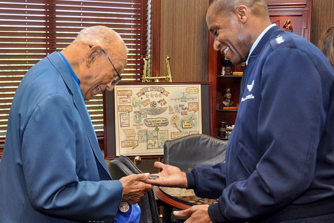 The commander of the U.S. Transportation Command meets with the oldest living Tuskegee airman.