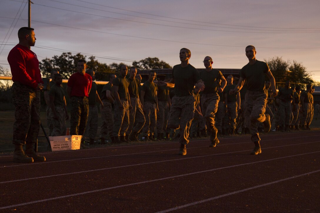 Marine recruits run 880 meters during a fitness test.