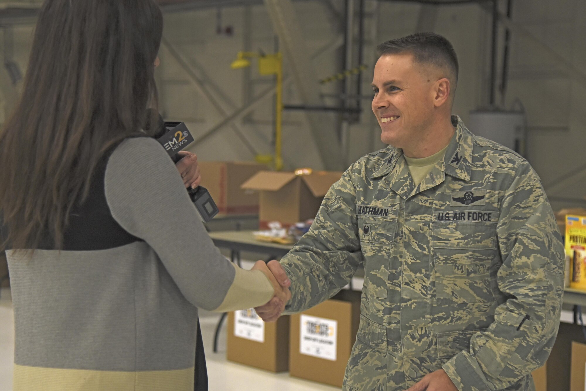 Col. Scot Heathman, 92nd Air Refueling Wing vice commander, talks with KREM 2 News anchor, Laura Papetti, about the benefits of the Treats 2 Troops initiative during a live interview Nov. 29, 2017, at Fairchild Air Force Base, Washington. KREM 2 News partnered with Team Fairchild for the seventh year in a row to fill care packages with small treats and gifts to help benefit military members serving overseas during the holiday season. (U.S. Air Force photo/Senior Airman Mackenzie Richardson)