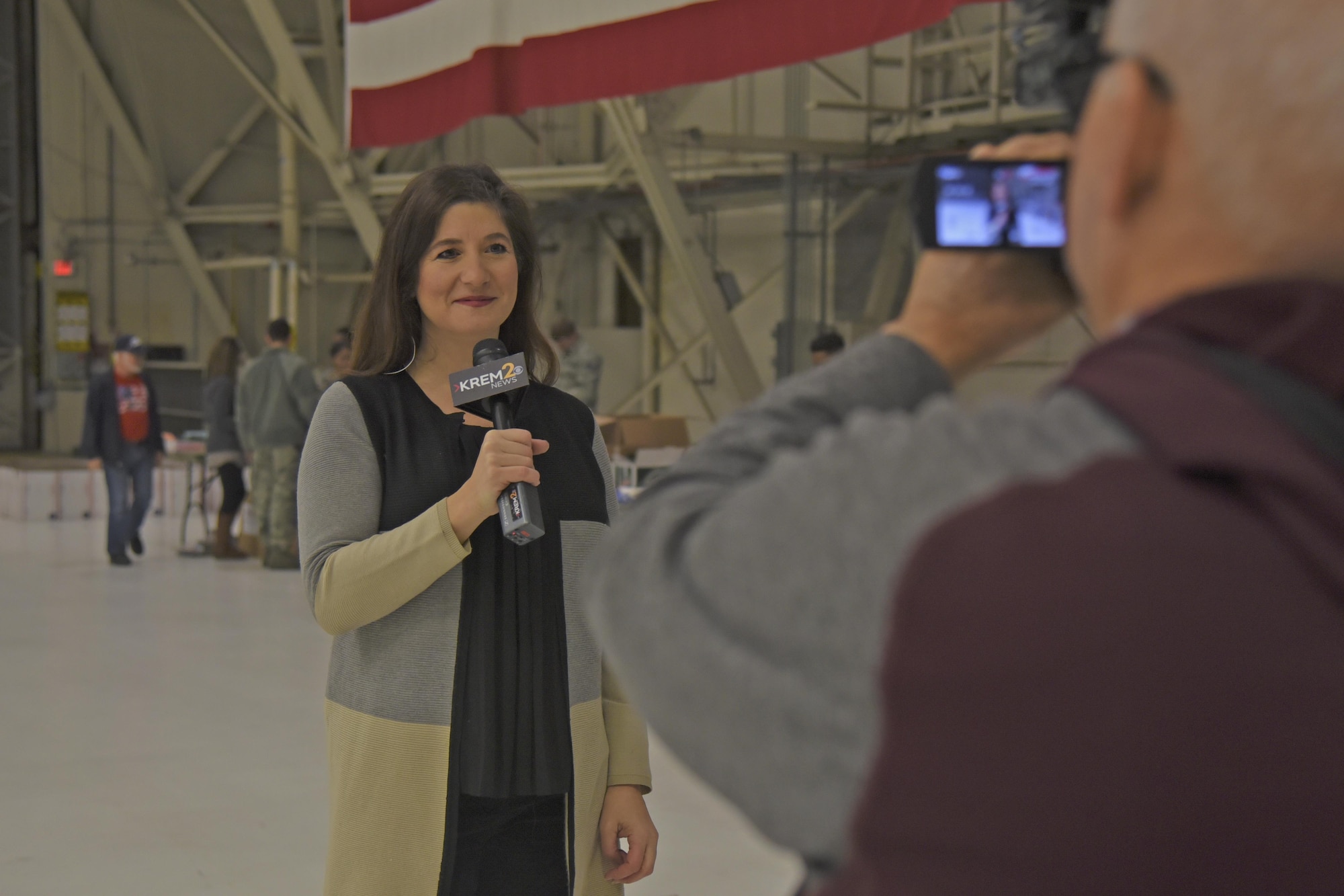 Laura Papetti, KREM 2 News anchor, does a live broadcast of the Treats 2 Troops effort Nov. 29, 2017, at Fairchild Air Force Base, Washington. Treats 2 Troops contributions are not only distributed to Air Force members from Fairchild; our sister services, including the Army, Navy and Marines, also receive packages from the Inland Northwest community.  (U.S. Air Force photo/Senior Airman Mackenzie Richardson)