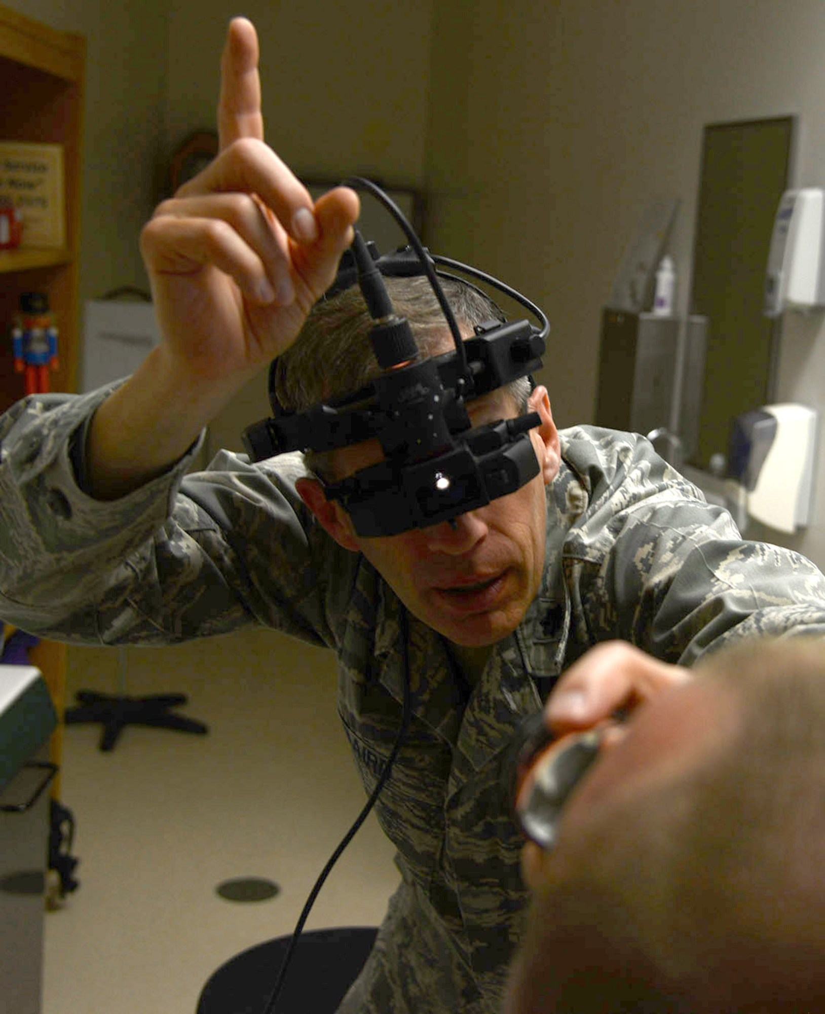 Dr. (Lt. Col.) Richard Baird, an optometrist with the 412th Medical Group, examines a patients eyes. Baird was recently selected as both the Air Force Optometrist of the Year as well as the Armed Forces Optometrist of the Year. (U.S. Air Force photo by Christopher Ball)