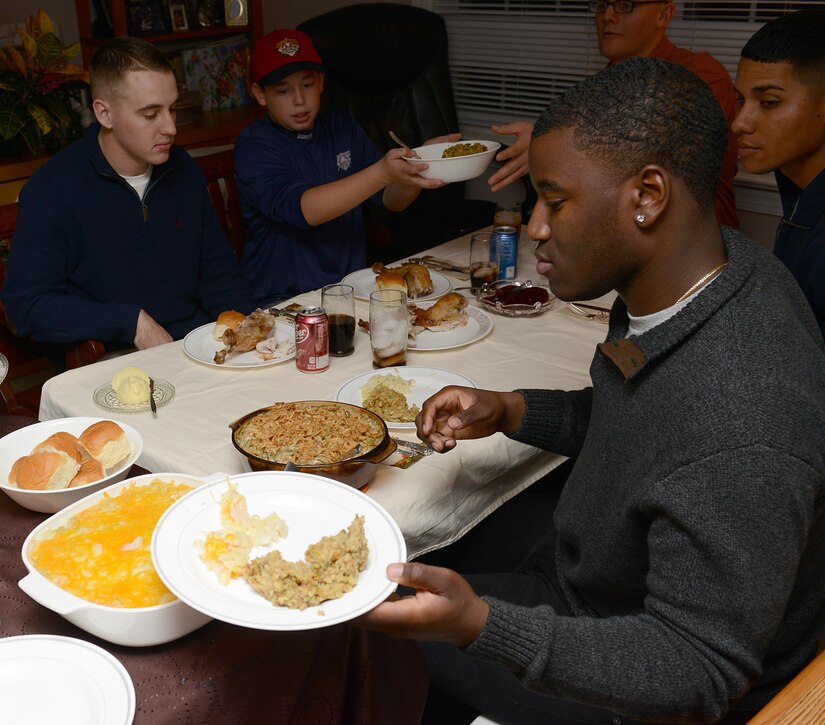 U.S. Army Soldiers assigned to the 128th Aviation Brigade participate in Thanksgiving dinner at the Deaver home in Yorktown, Va., Nov. 23, 2017.