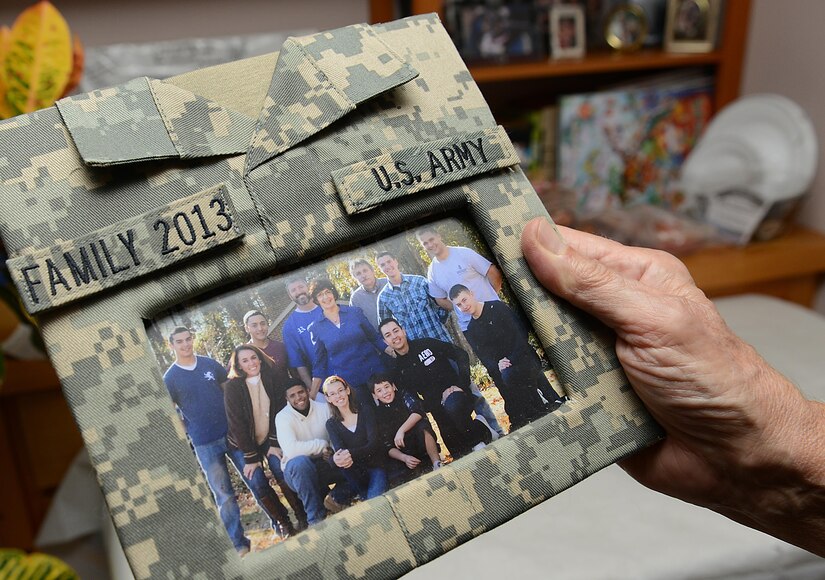 Janice Griffin holds a framed photo of her family and U.S. Army Soldiers at her home in Yorktown, Va., Nov. 23, 2017.