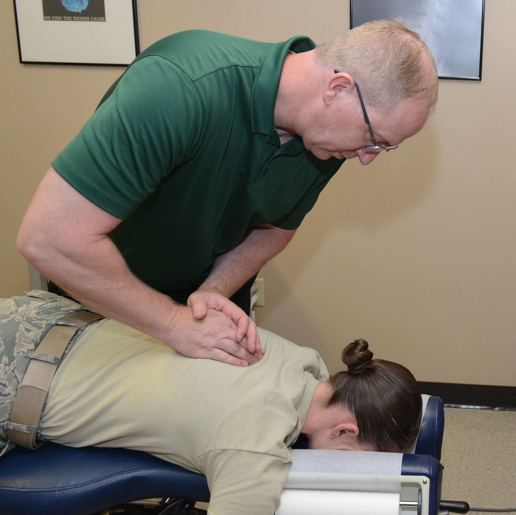 Doug Beaudette, 56th Medical Operations Squadron chiropractic physician, performs an adjustment on Tech. Sgt. Alexandria Valdez, 56th MDOS physical therapy clinic noncommissioned officer in charge, at Luke Air Force Base, Ariz., Nov. 21, 2017. Beaudette takes care of more than 20 patients daily as the sole chiropractic physician at Luke. (U.S. Air Force photo/Senior Airman James Hensley)