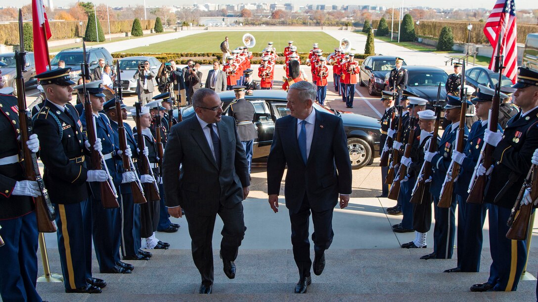 Defense Secretary James N. Mattis walks up steps with Bahraini Crown Prince Salman bin Hamad al Khalifa.